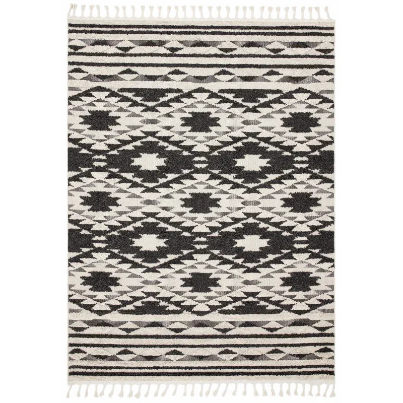 Black and white geometric patterned rug with fringed edges