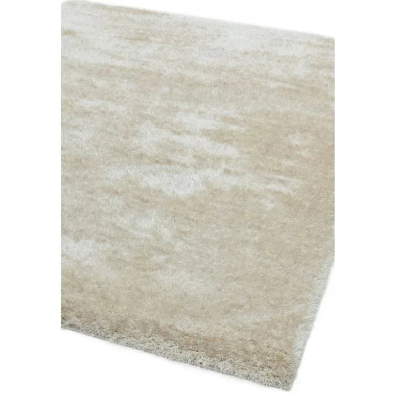 Cream shaggy rug with thick pile, close up on corner detail and soft texture