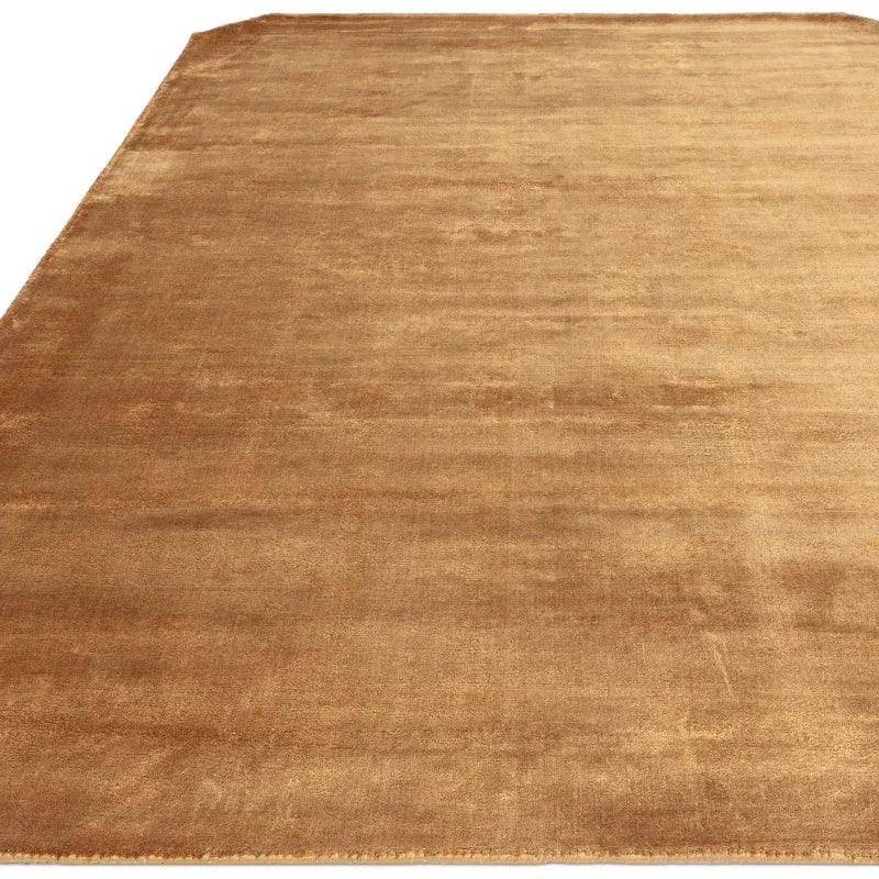 Plain brown area rug with soft texture and medium pile on a white background