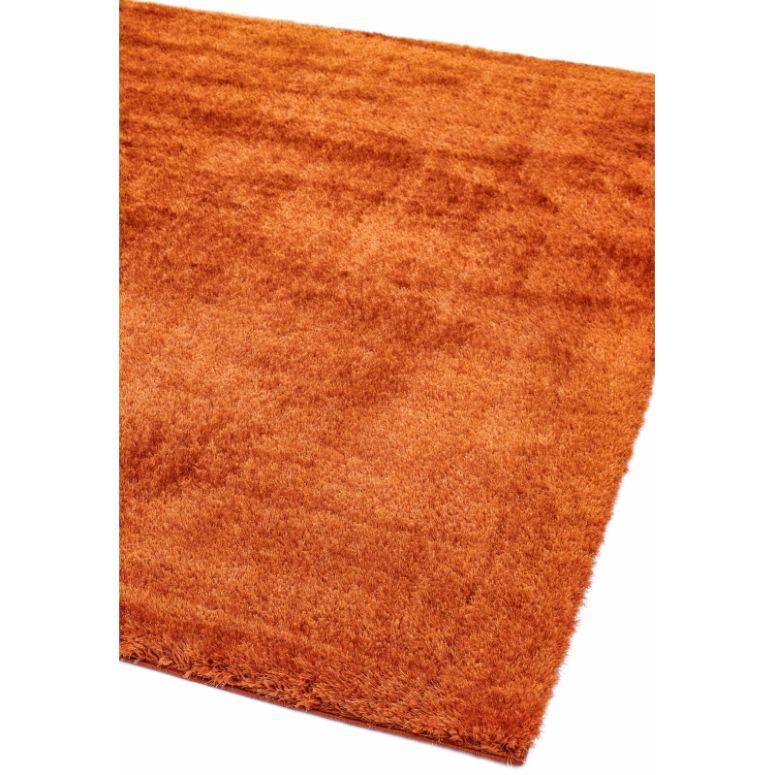 Orange shaggy area rug with soft texture, shown from corner angle