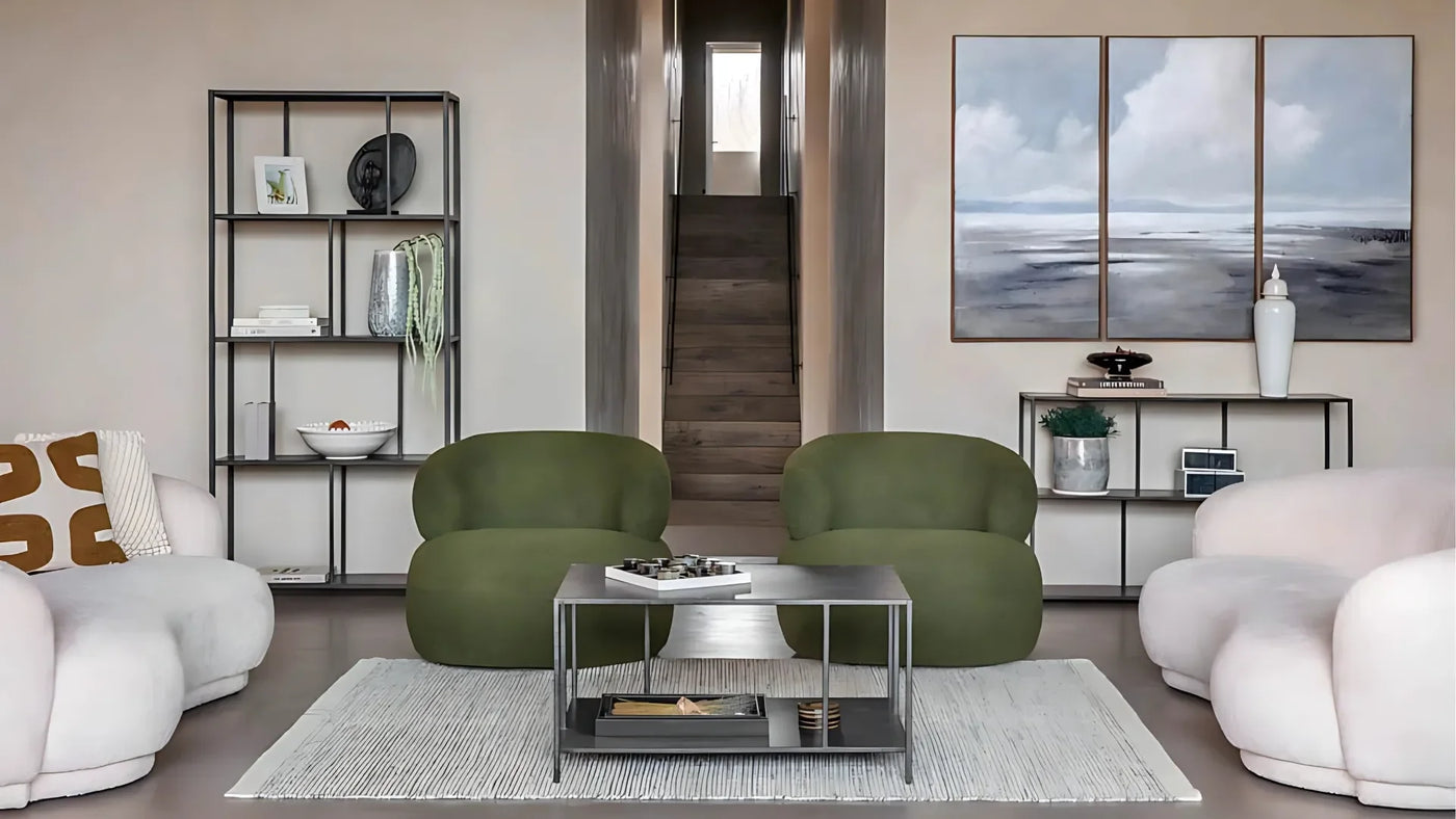 Modern living room with green sofas, cream armchairs and metal coffee table on rug