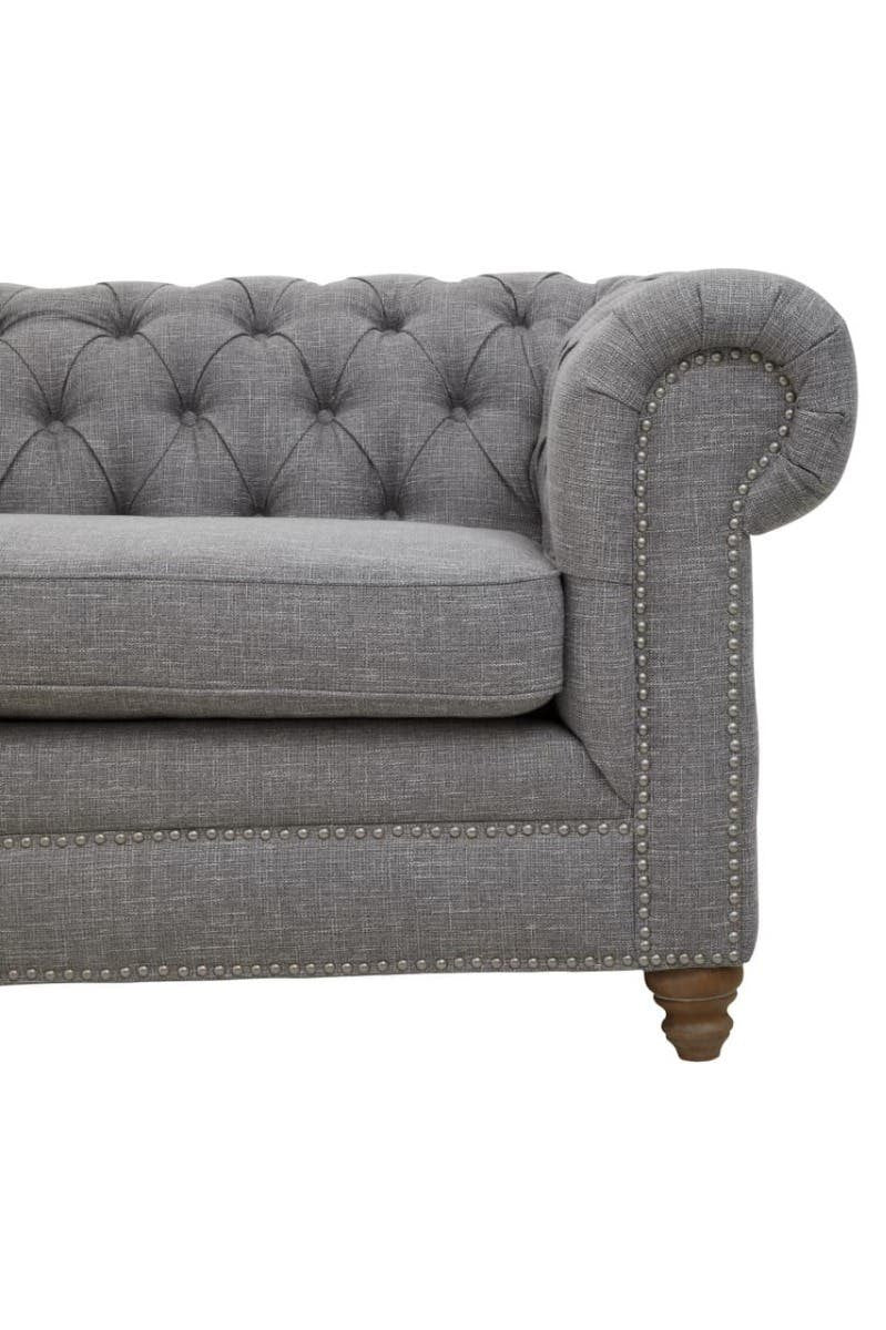 Three-seat sofa upholstered in grey linen with a tufted backrest and rolled arms, featuring wooden legs