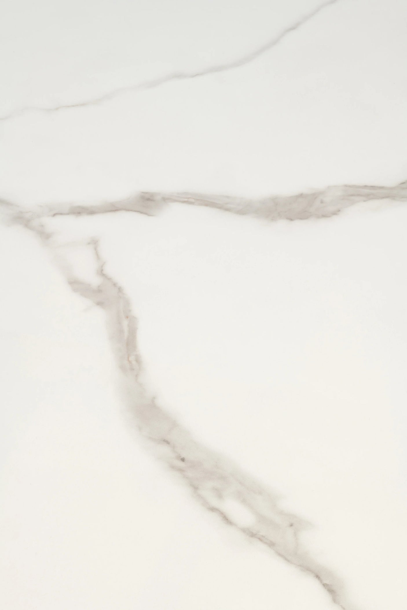 White marble tabletop close up with subtle grey veining pattern