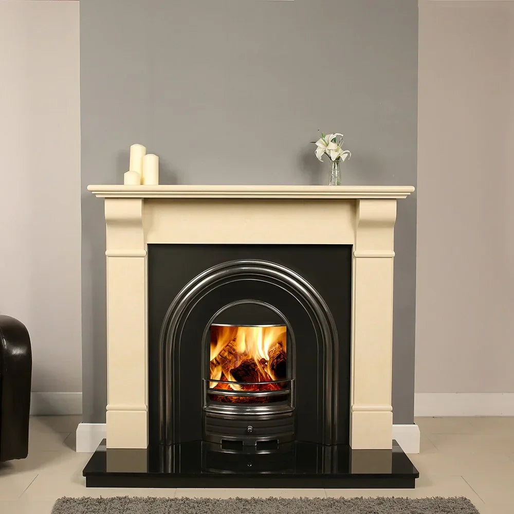 Cream limestone fireplace with black cast iron insert and real fire burning, modern room setting