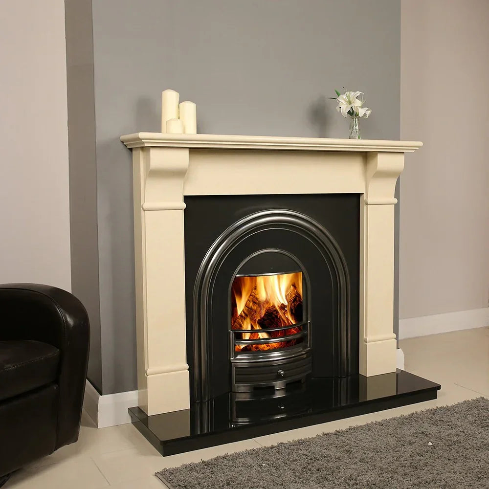 Cream limestone fireplace with black hearth and inset fire burning in modern living room