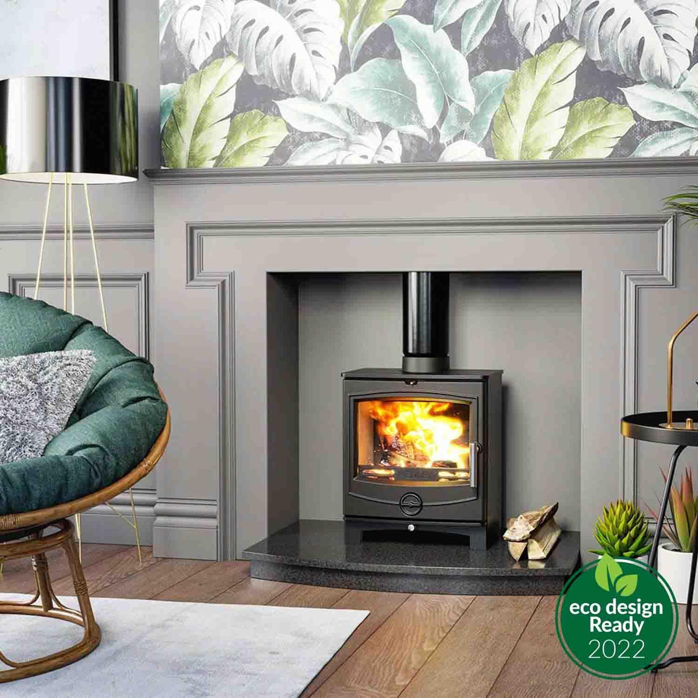 Black wood burning stove with glass door in grey fireplace, burning fire, eco design badge