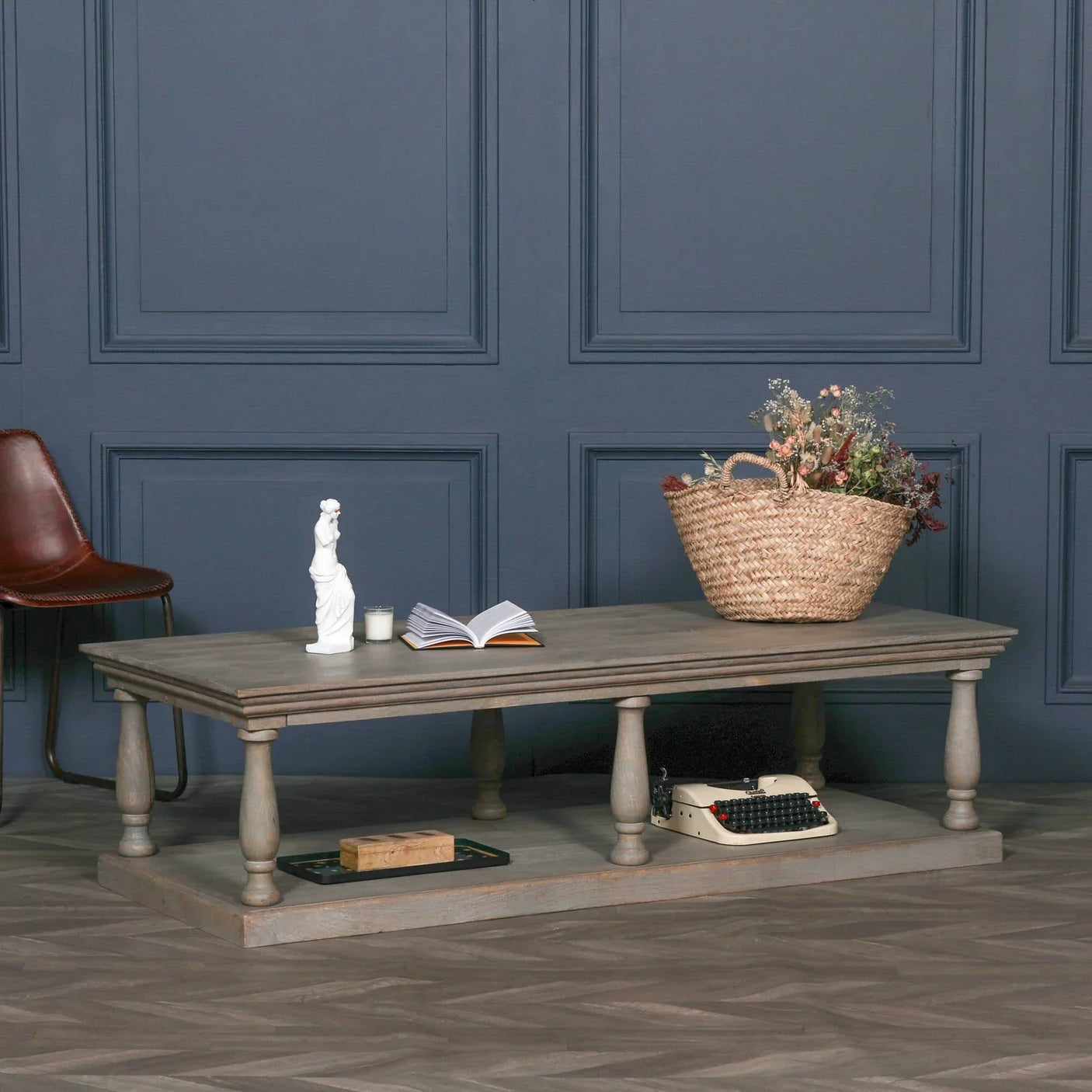 Rustic wooden coffee table with lower shelf, decor accents and wicker basket on top