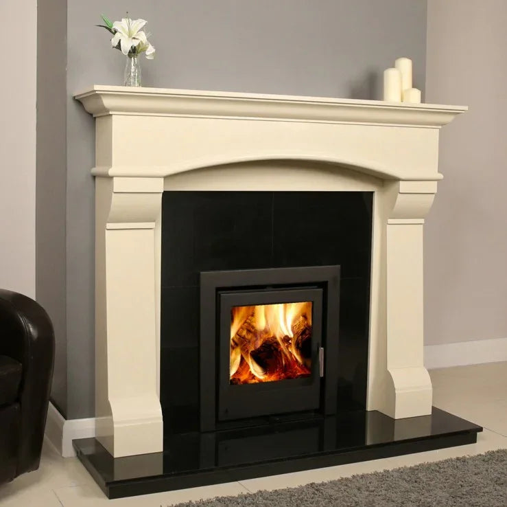 Modern fireplace suite with cream stone surround and black wood burning stove in living room