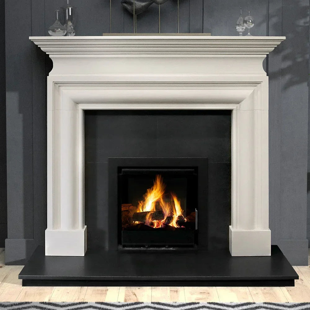 Wallace 60 limestone fireplace with black hearth and wood burning stove in modern living room