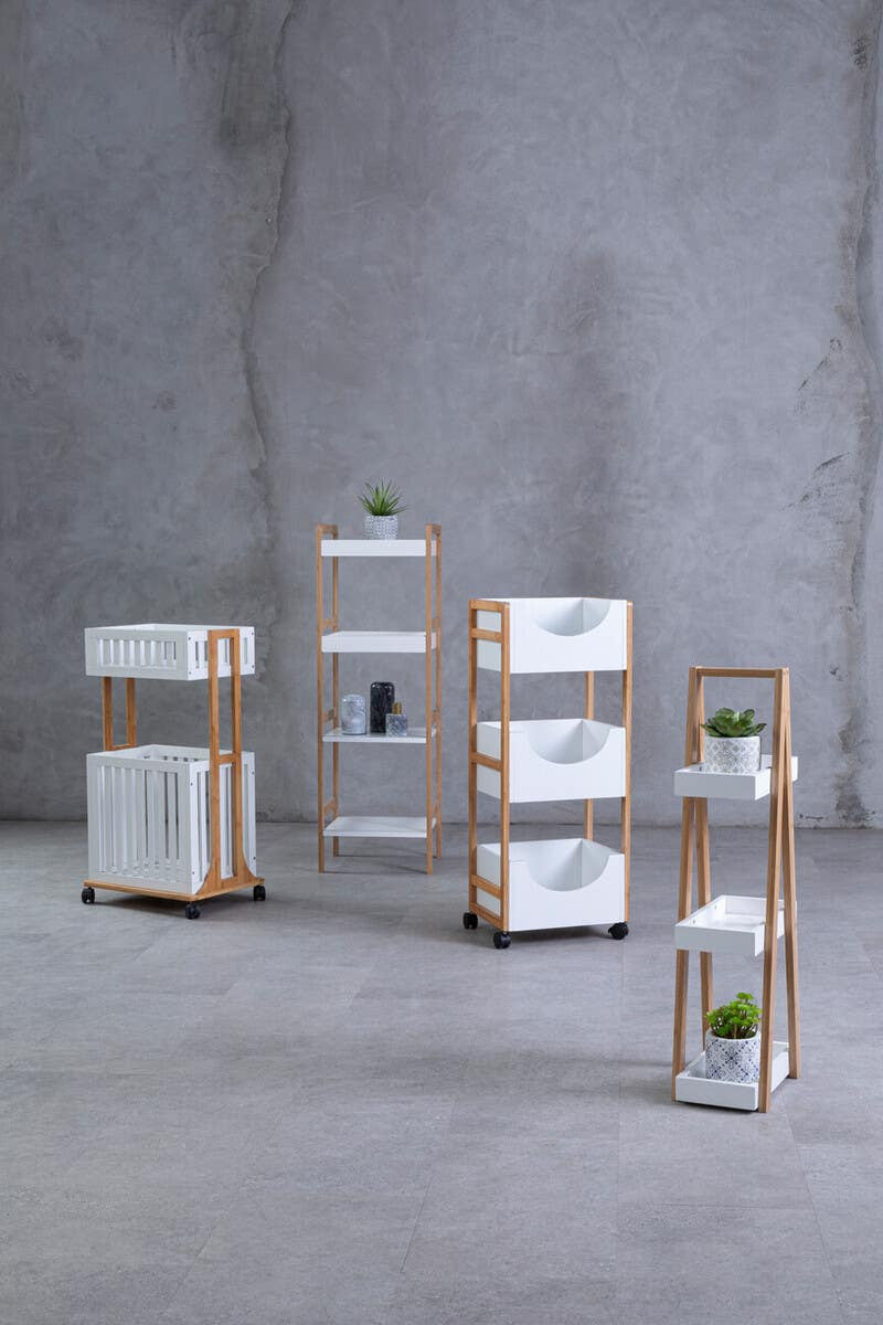 Four tiered shelf unit featuring a combination of white and natural wood finishes. The unit includes multiple shelves and drawers, with a minimalist design. The background is a textured gray wall, enhancing the modern aesthetic of the furniture