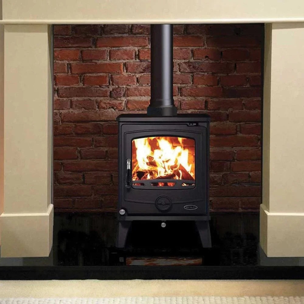 Buy wood burning stove online, black fireplace heater in front of brick wall, home heating