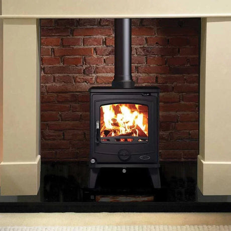 Buy wood burning stove online, black fireplace heater in front of brick wall, home heating