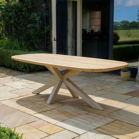 Rectangular wooden outdoor dining table with cross leg base on patio