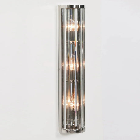 chrome wall light with vertical crystal rods and exposed bulbs mounted on white wall