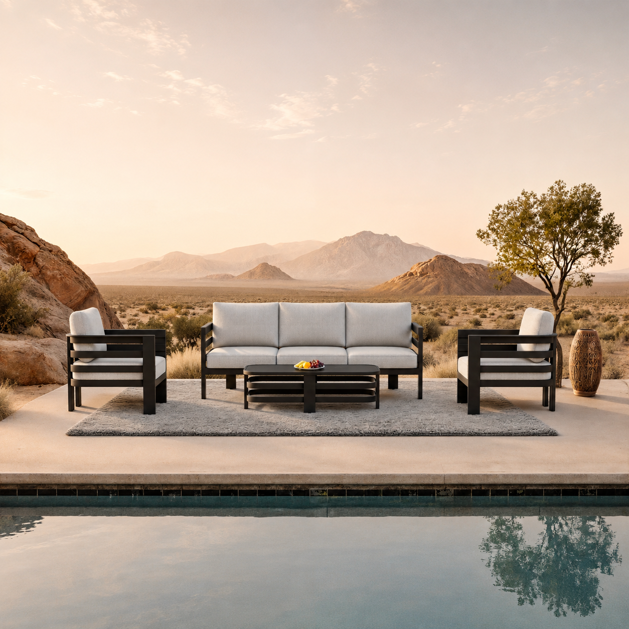 Light grey cushioned seating with black metal frame on grey outdoor rug by poolside | Home Centre Di