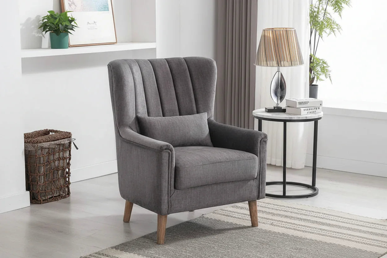Graphite upholstered armchair with wooden legs beside a round side table in modern living room