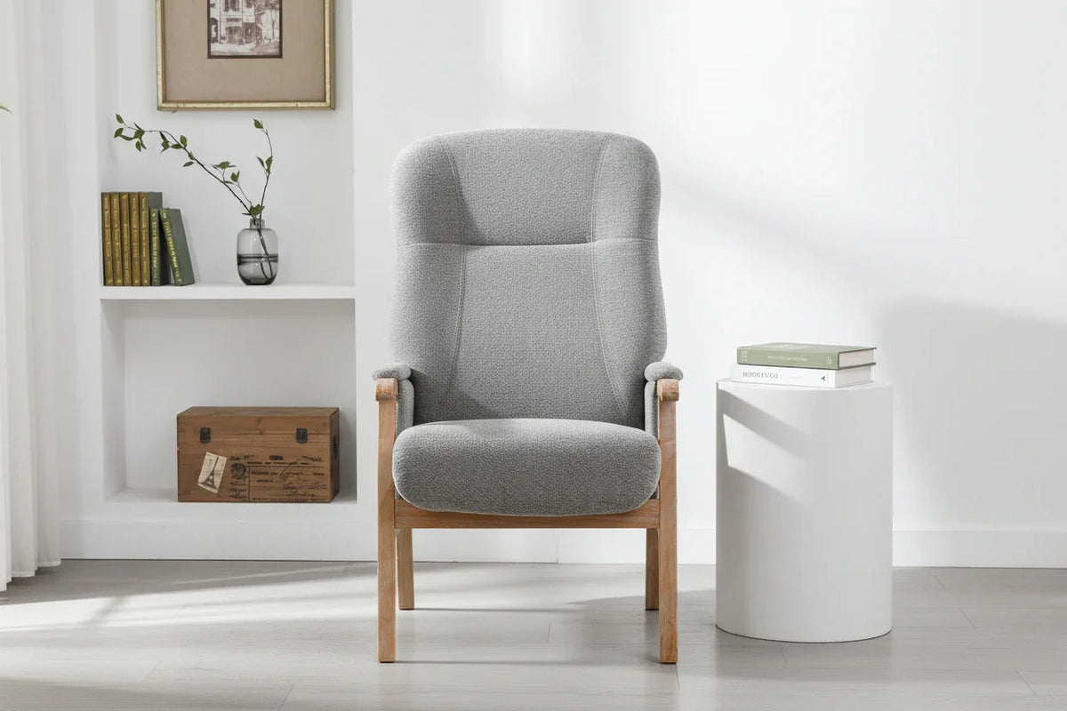 Grey upholstered armchair with wooden frame in modern living room setting