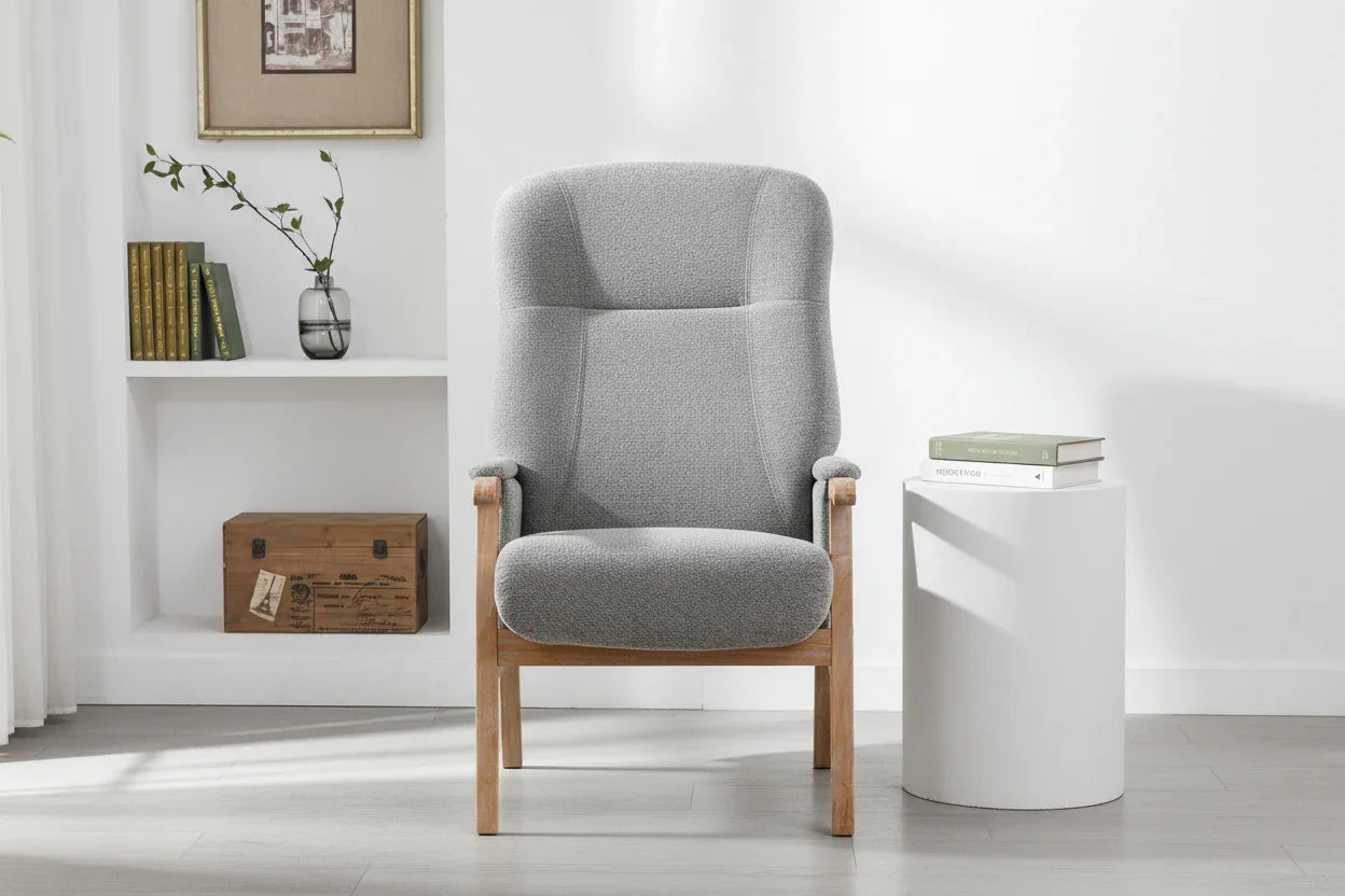 Grey upholstered armchair with wooden frame in modern living room setting