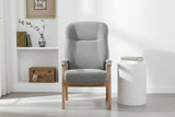 Grey upholstered armchair with wooden frame in modern living room setting