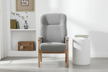 Grey upholstered armchair with wooden frame in modern living room setting
