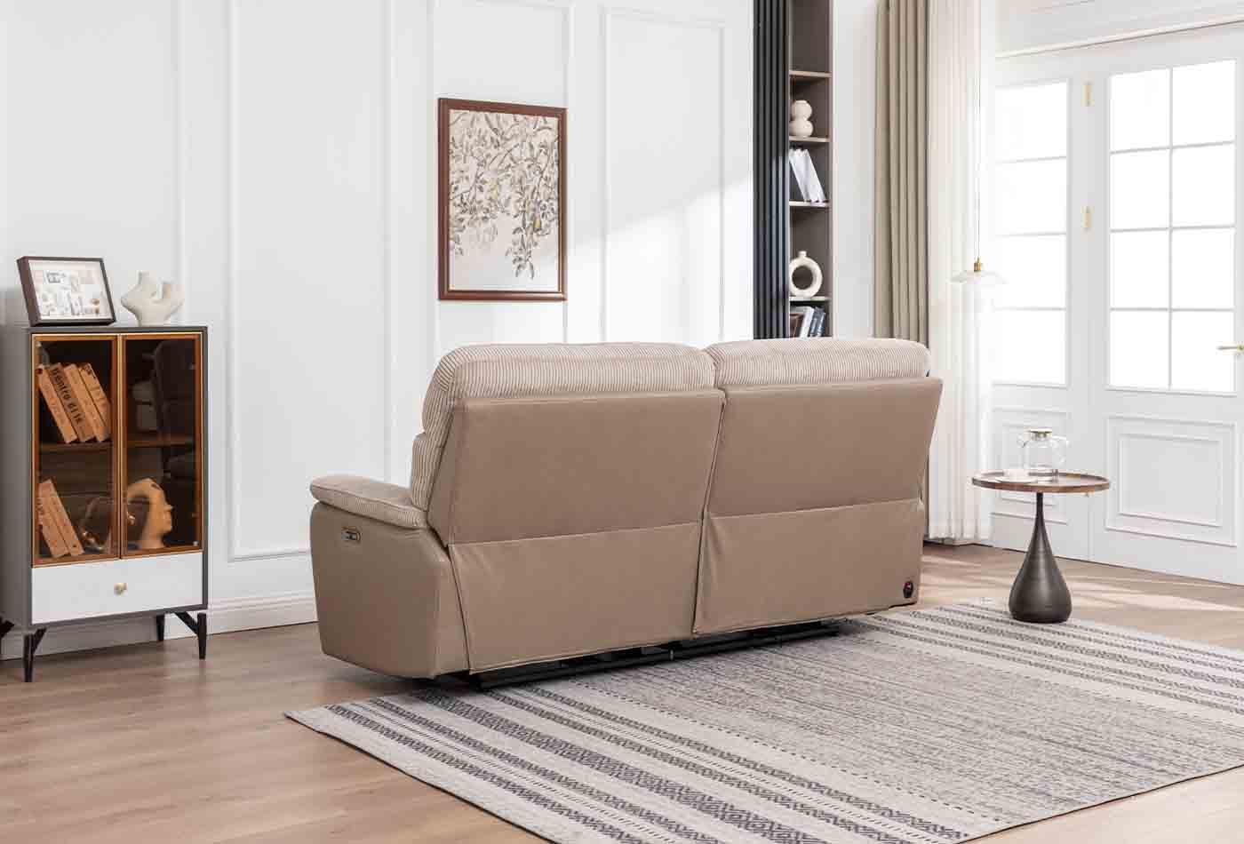 Beige two-seater sofa with fabric backrest in modern living room on striped rug