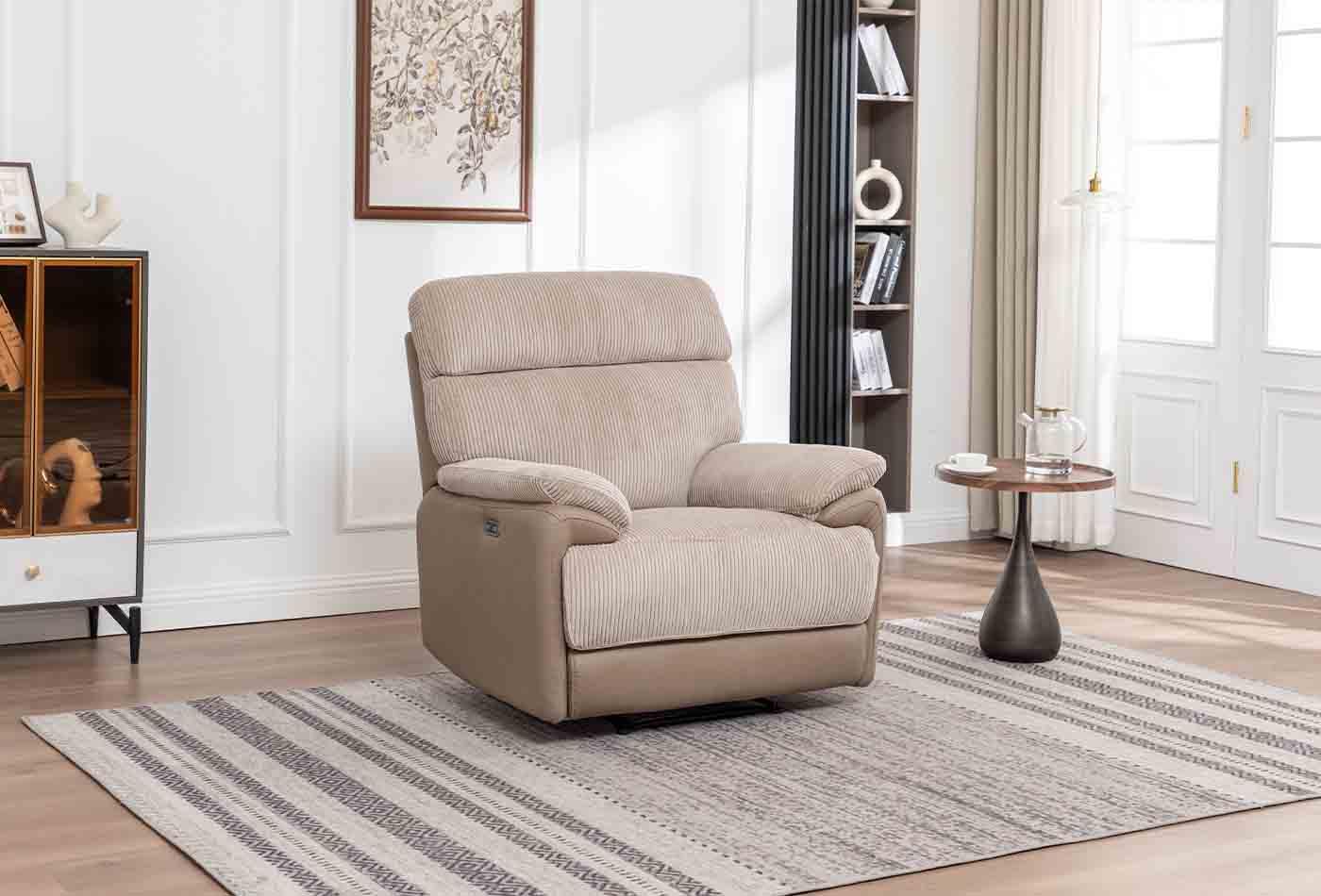 Beige fabric 1 seater armchair with wide armrests in modern living room setting on striped rug