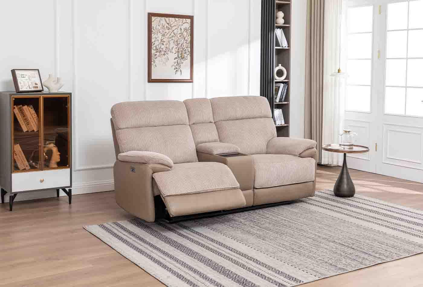 Beige two seater sofa with console and footrest in a modern living room