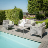 Grey rope garden sofa set with coffee table and cushions beside swimming pool