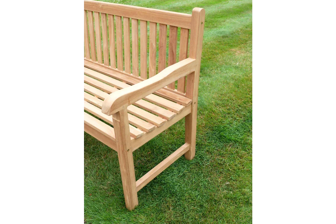 teak garden bench with slatted seat and backrest on grass lawn, side arm detail visible