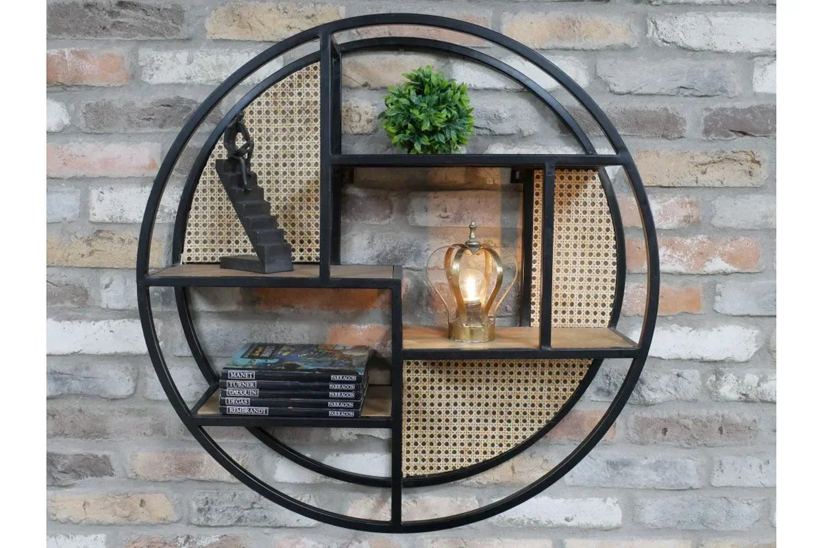 Round wall shelf with black metal frame, rattan panels, decorative items and books