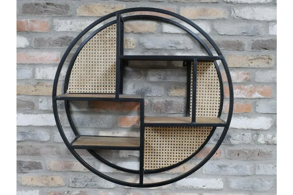 Round metal and wood wall shelf with rattan panels on exposed brick wall