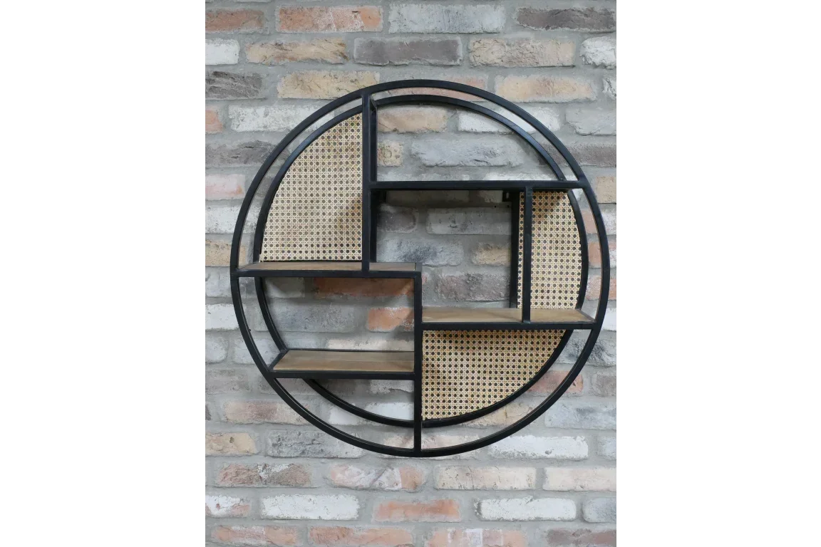 Round metal wall shelf with rattan panels and wooden shelves against brick wall