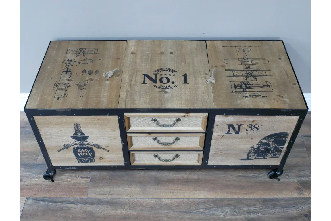 Industrial wooden storage trunk with vintage graphic prints and three central drawers