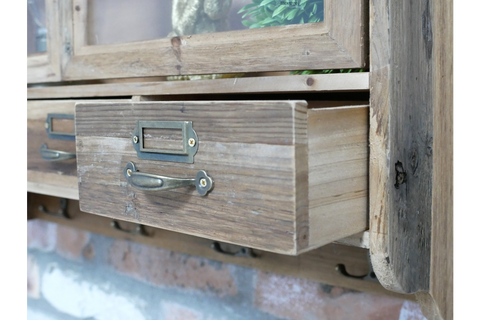 Rustic wooden wall unit with open drawer, metal handle, and label holder, angled view showing textured wood grain.