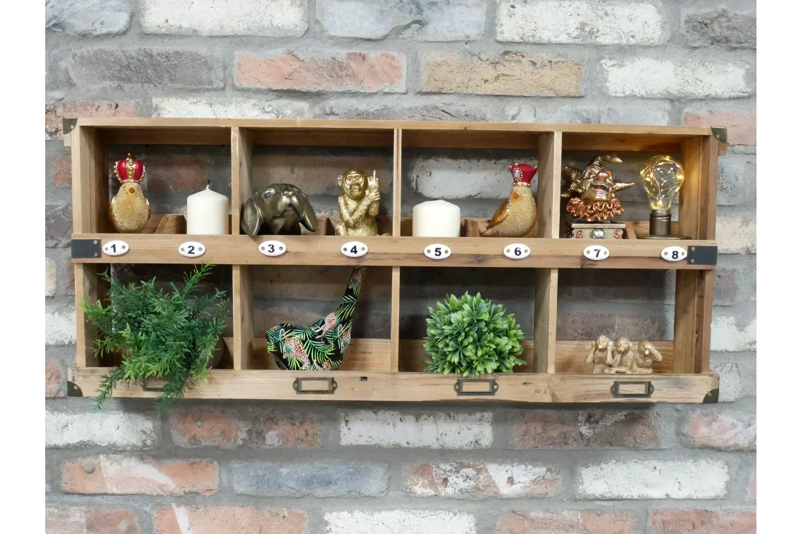 Wooden wall mounted shelf unit with decorative ornaments, artificial plants, and candles