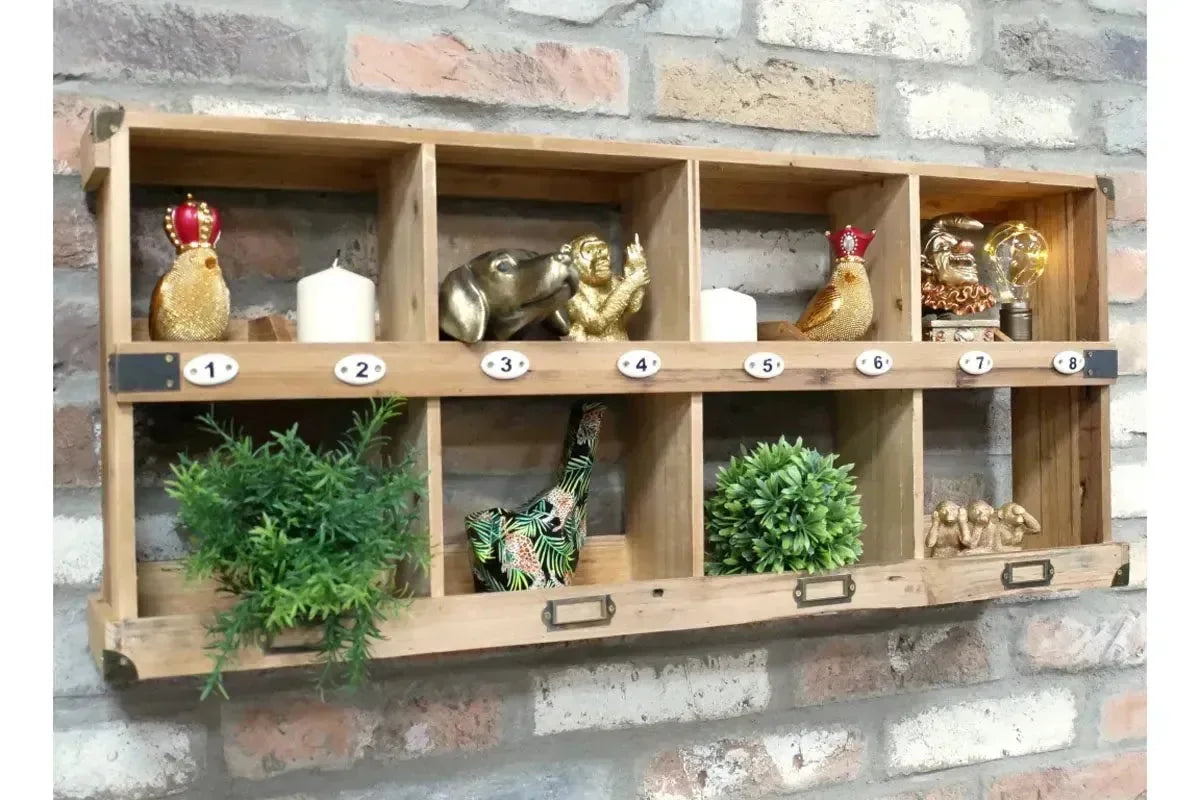 Wooden wall shelf unit with eight cubby holes displaying plants, ornaments and candles