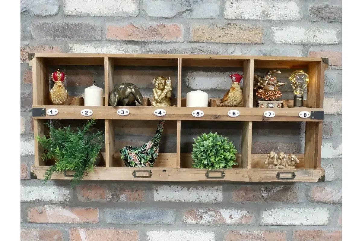 Rustic wooden wall shelf unit with eight compartments displaying ornaments and plants