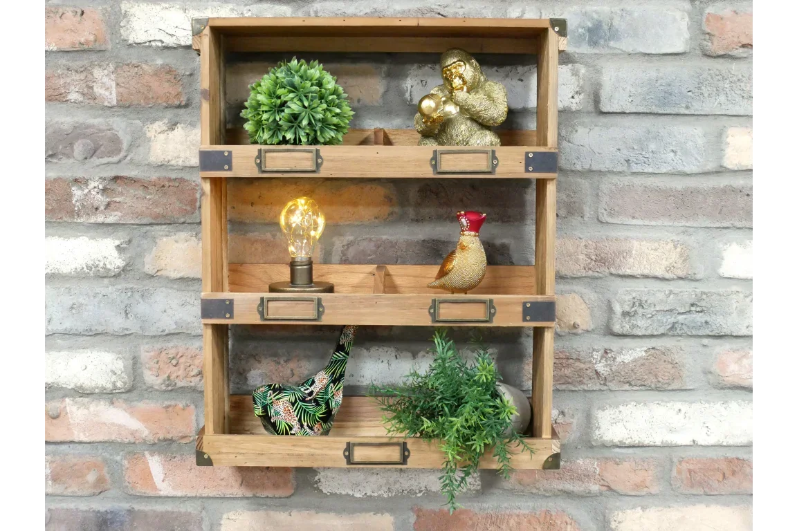 Wooden wall shelf with plants, decorative figures, and exposed bulbs against brick wall