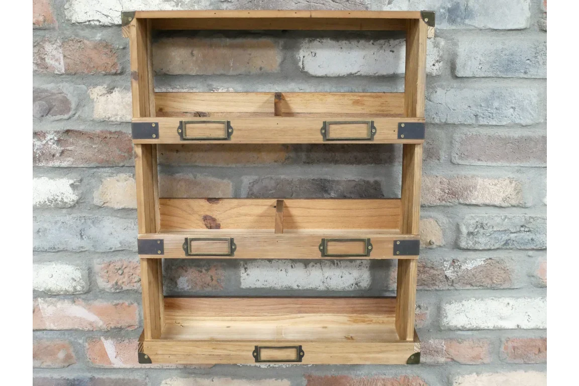 Three tier wooden wall shelf with metal brackets and label holders against brick wall