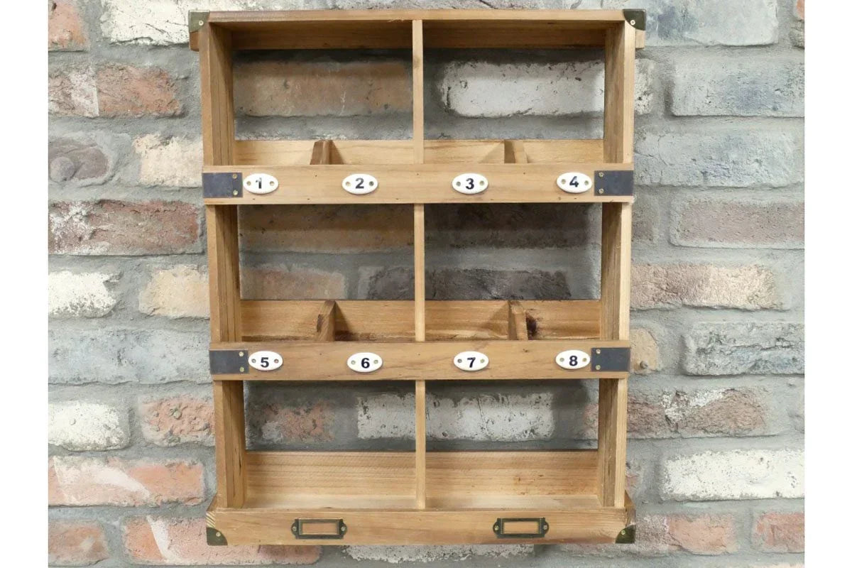 Wooden wall mounted storage shelf unit with numbered compartments against brick wall