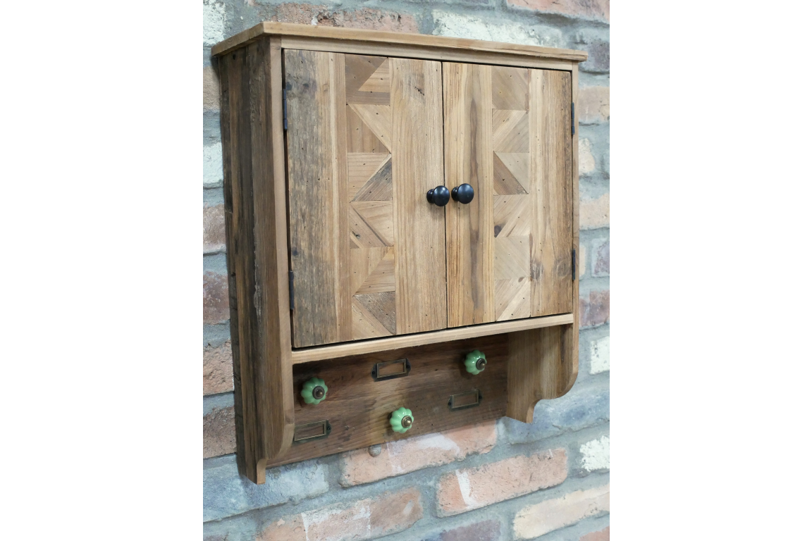 Wall-mounted wooden wall unit with doors, black handles, three green ceramic hooks, rustic reclaimed wood finish, angled
