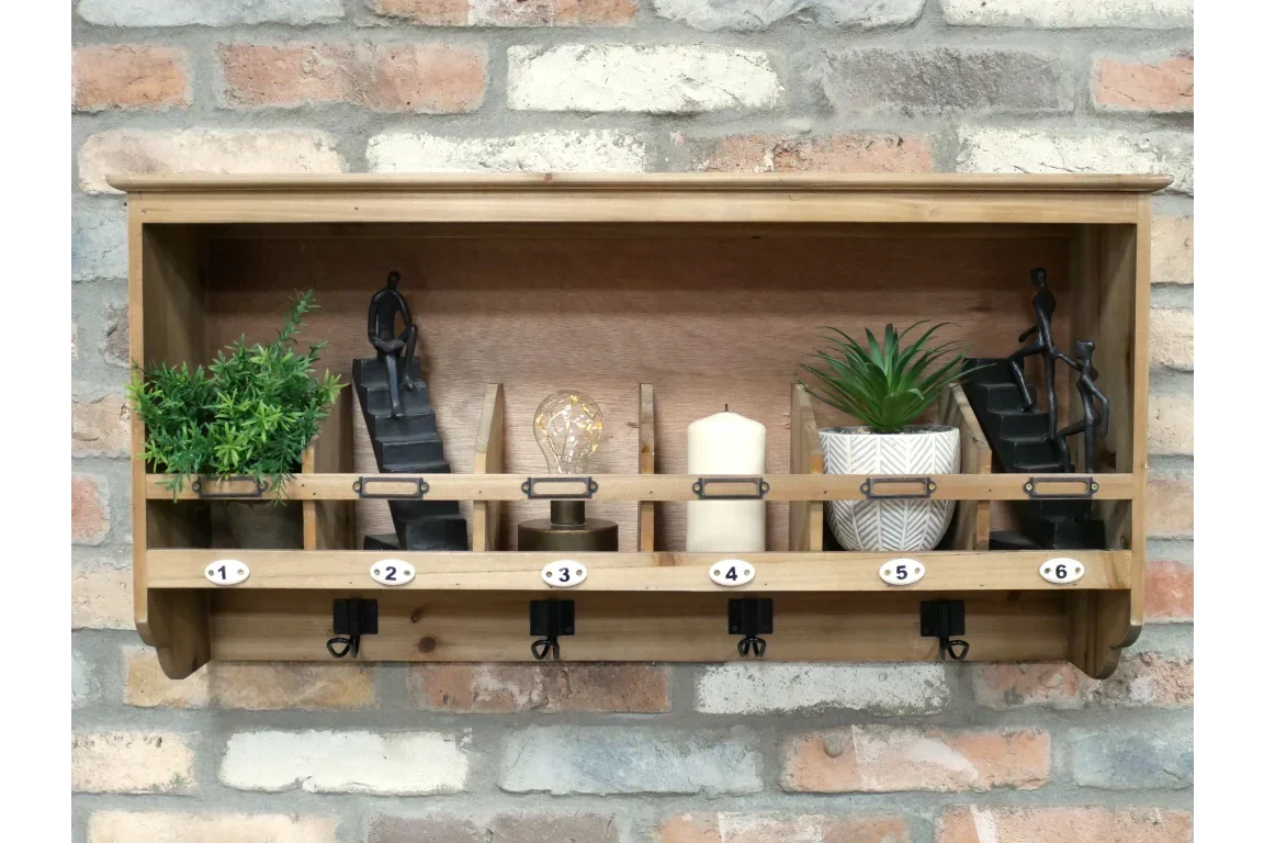 Wall mounted wooden shelf with numbered hooks, decor, and plants against brick wall