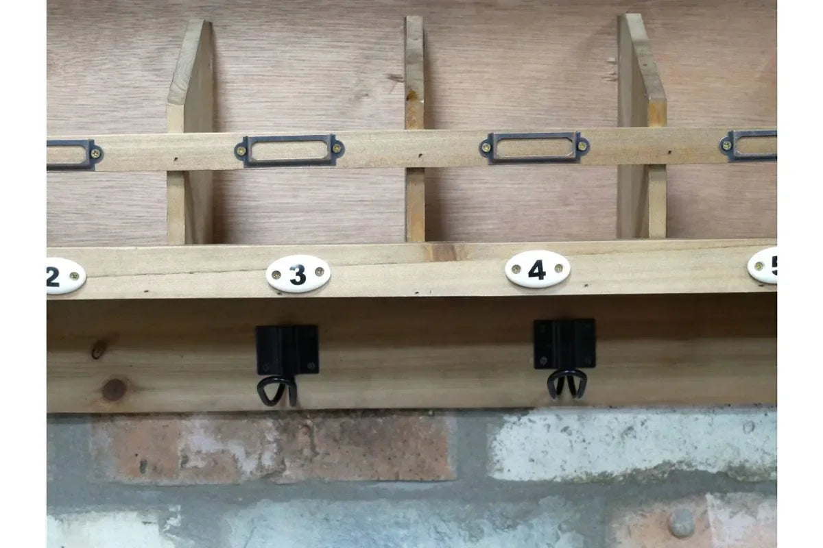 Wooden wall-mounted coat rack with numbered hooks and storage compartments