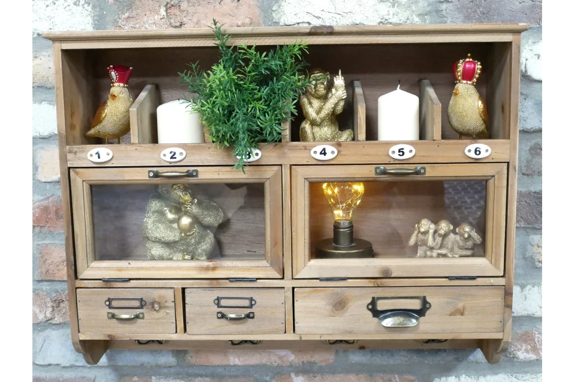 Wall mounted wooden display shelf with glass doors, gold animal ornaments, candles, and plant