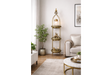 Tall 3 tier gold metal shelves with decorative items, in a neutral living room setting, angled front view.