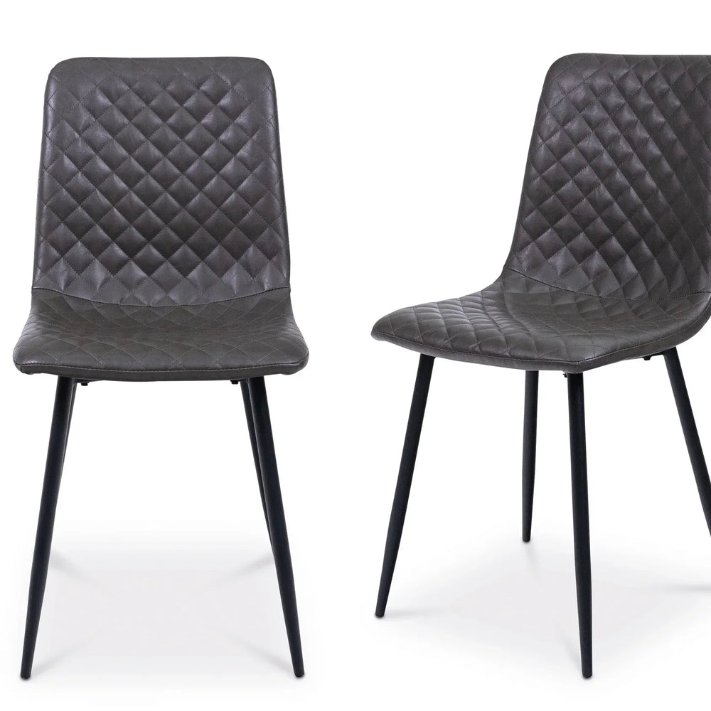 Set of two grey dining chairs with diamond-stitched upholstery and black metal legs