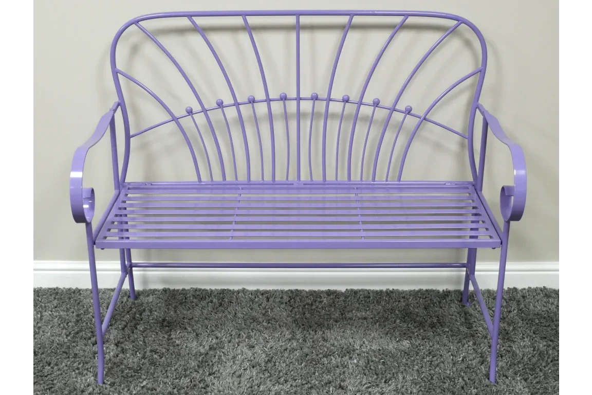 Purple metal garden bench with slatted seat and decorative curved backrest on grey carpet