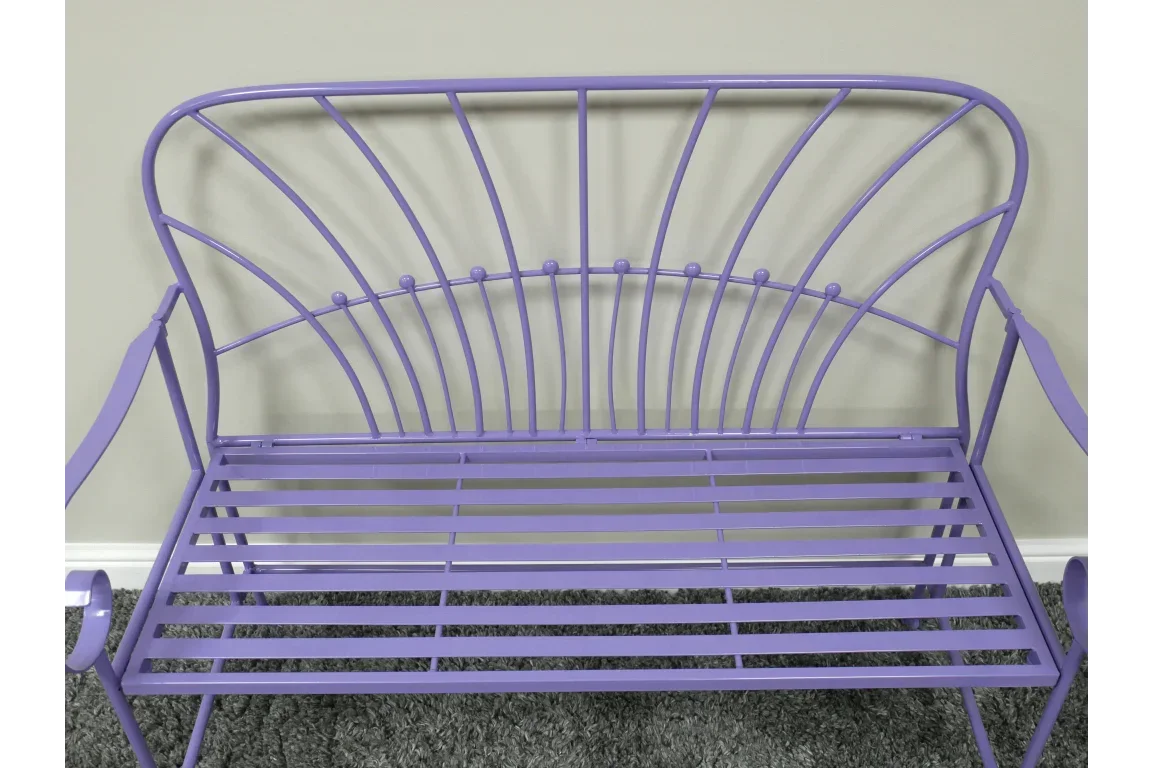 Purple metal garden bench with curved backrest and slatted seat on grey carpet