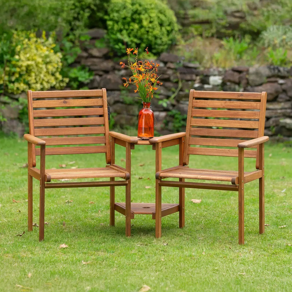 Wooden garden companion bench set with built-in table and orange vase on lawn