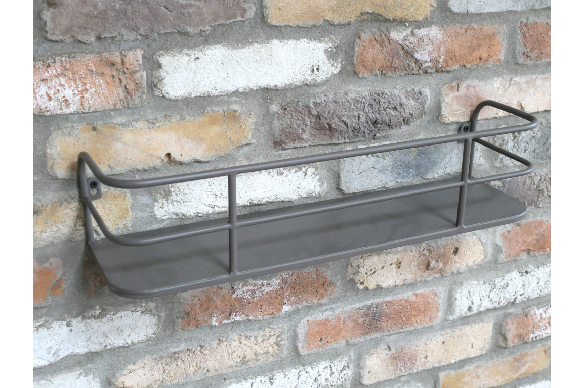 Wall-mounted grey metal shelf with raised bars, angled view against a textured brick wall background.